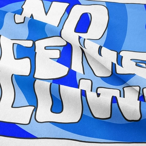 Close-up of bohemian tapestry fabric with blue swirl print and bold white typography