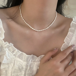 Primo piano di un'elegante collana di perle d'acqua dolce indossata sul collo