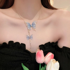 Blue butterfly layered necklace with diamonds and pearls on female model