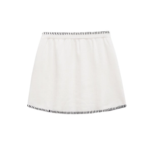 White knitted skirt featuring contrasting black hand-stitched hem and minimalist design