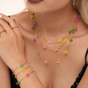 Multilayer gold chain jewelry set with colorful beaded flowers on a female model