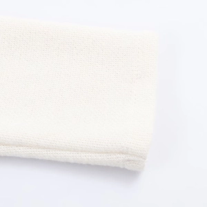 Close-up of white knitted cuffs showing detailed texture and high-quality craftsmanship