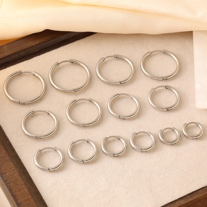 Polished silver hoop earring set in multiple sizes on velvet display tray