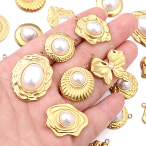 Detailed view of assorted golden sunflower charms with embedded white pearls