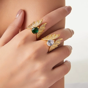 Bohemian wing rings in gold finish with pear-cut green and clear zircon stones