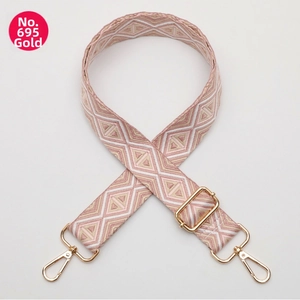 Adjustable woven replacement bag strap with pink geometric diamond pattern and gold metal hooks