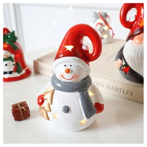 Macro shot of glowing snowman figurine with star cutouts and warm yellow LED lighting