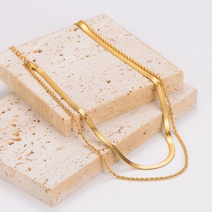 Gold double-layered necklace featuring twisted rope chain and flat snake chain design