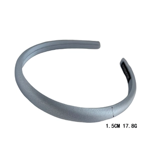 Detail view of 1.5cm slim grey satin headband with handmade label on white background
