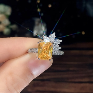 Macro shot of princess cut yellow zircon ring with floral halo and marquise accents