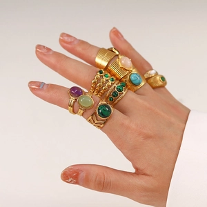 Detailed view of various vintage 18k gold plated stainless steel rings with colorful gemstones