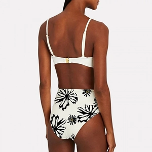 Back view of white bikini set with black floral print and gold buckle closure