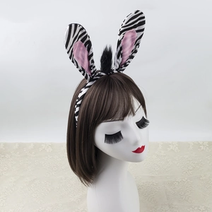 Plush zebra ears headband with pink inner lining on a white mannequin head display