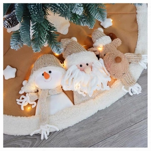 Detailed view of plush Christmas tree skirt with 3D snowman and Santa doll characters