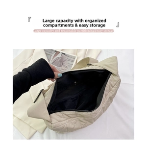 Macro shot of spacious interior with zipper pocket in a beige quilted shoulder bag