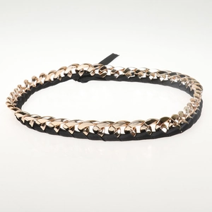 Detail of gold metal chain woven with black ribbon for DIY hats and belt accessories
