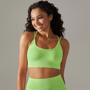 Detail of neon green seamless sports bra with ribbed hem and matching leggings