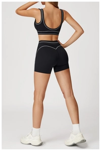 Rear view of high-waist yoga shorts and sports vest with white contrast piping trim