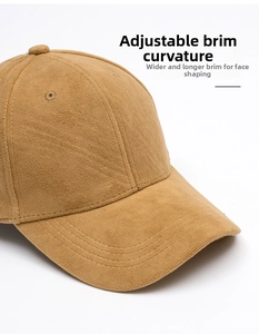 Detail of camel faux suede baseball cap showing foldable brim and reinforced stitching