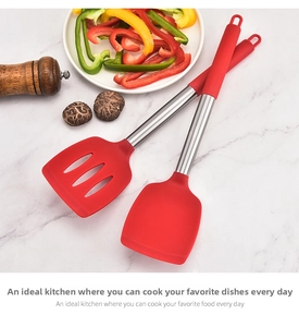 Close-up of red silicone solid and slotted spatulas set on a marble background