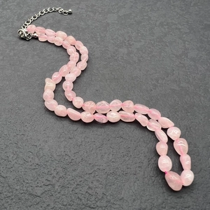 Detail view of irregular rose quartz beads necklace with stainless steel lobster clasp