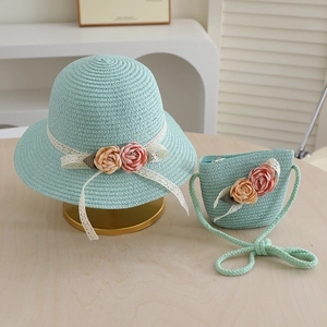Detail of mint green straw hat and bag set with white lace and fabric rose flowers