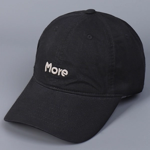 Close-up of premium black cotton baseball cap with white More letter embroidery on front