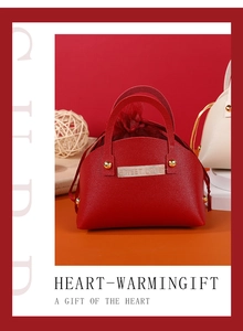 Macro detail of red leather gift box with Sweet Love gold plate and mesh lining