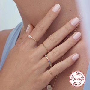 Detail of 925 sterling silver rings with colorful zircon and stones on model hand