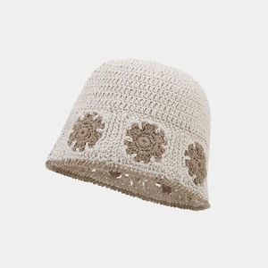 Detail of hand-crocheted bucket hat showing intricate floral pattern and cotton texture