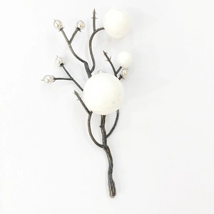 Detail view of artificial Christmas branches with white and silver berry foam ornaments
