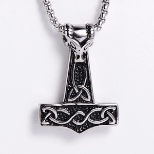 Detailed view of Viking Mjolnir pendant with goat head relief on steel pearl chain