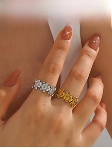 Detail of adjustable sunflower rings in gold and silver finishes on a model
