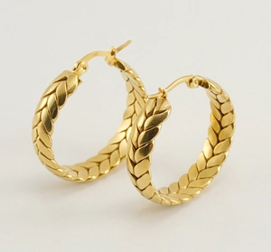 Detailed close-up of 18K gold plated stainless steel earrings with wheat pattern
