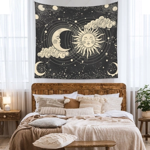 Bohemian sun and moon tapestry with gold celestial patterns over a cozy bedroom headboard