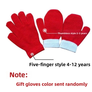 Close-up of red knit winter gloves with white ribbed cuffs for kids and toddlers