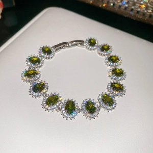 Macro detail of emerald-cut green crystal bracelet with shimmering silver plating