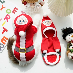 Detail view of red Christmas themed dog hoodie with Santa print and plush white pom-pom