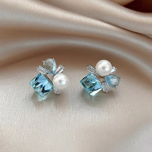 Elegant silver square blue crystal earrings with pearl and zircon on satin fabric