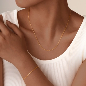 Minimalist gold link chain necklace and bracelet set featuring delicate oval loops for women