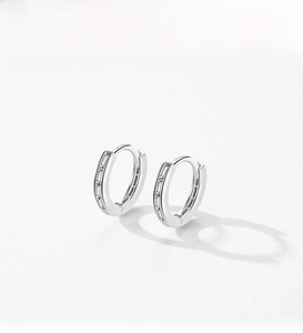 Detailed view of S925 sterling silver hoop earrings with set cubic zirconia stones