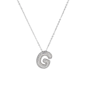 Macro detail of silver bubble letter G pendant with shimmering zircon pavé stones