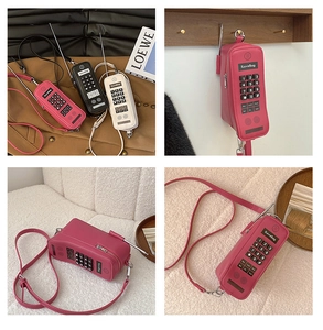 Macro detail of retro mobile phone shaped shoulder bag with zip closure and chain