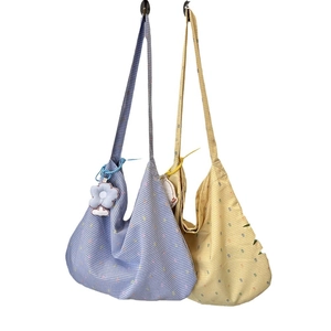 Floral cotton tote bags in blue and yellow with plaid patterns and flower charms