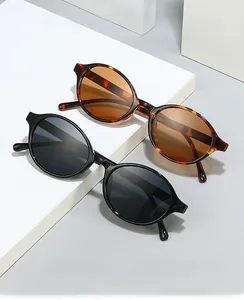 Close-up of retro oval sunglasses in tortoise shell and black frames on geometric blocks