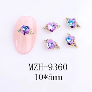 Detail of purple heart crystal nail art charms with gold base and white accent diamonds