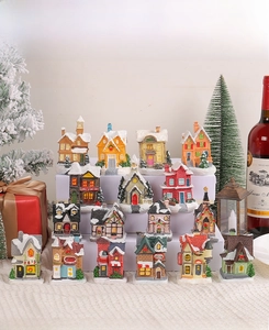 Detailed view of 16 miniature resin Christmas village houses with snowy rooftops