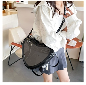 Detail of heart-shaped ita bag with transparent window shown on model in Japanese style