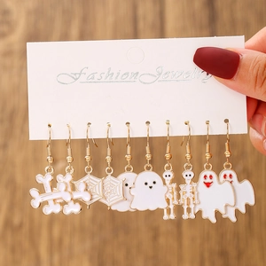 Detailed view of nine pairs of Halloween ghost and spider web earrings on display card