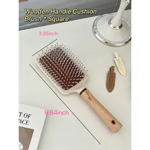 Detailed size measurement of wooden air cushion massage hairbrush on a white desk